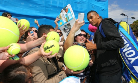 Fans mob Nick Kyrgios with giant tennis balls at Melbourne Park.