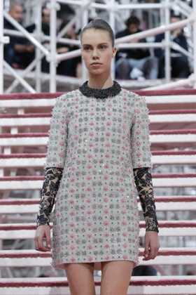 A model presents a creation by Belgian designer Raf Simons as part of his haute couture spring summer 2015 fashion show.