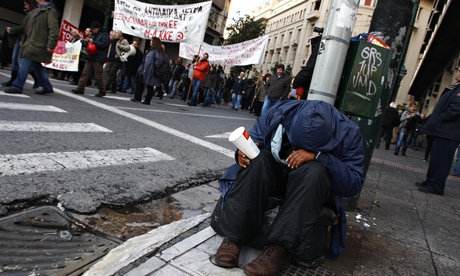 A man begs on a street in Athens 