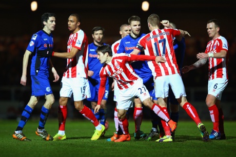 Peter Vincenti of Rochdale clashes with goalscorer Bojan Krkic who goes into referee Martin Atkinson's book.