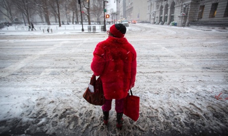 A woman waits to cross Centre Street near City Hall, New York City