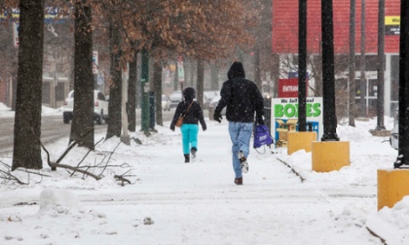 A man runs through falling snow in New Haven, Connecticut