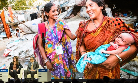 Bill and Melinda Gates against large screen