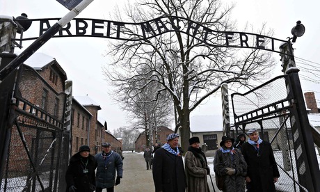 Auschwitz survivors at the infamous gate to the former Nazi concentration and extermination camp
