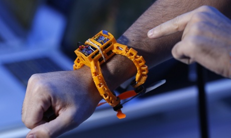A CES attendee wears a prototype Nixie camera drone