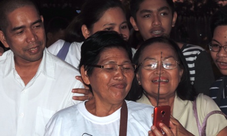 salvacion and her family watching the pope on a portable tv