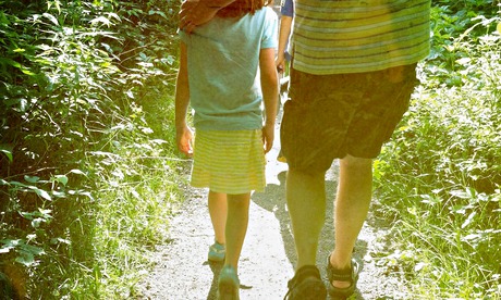 Father And Daughter Walking In Forest