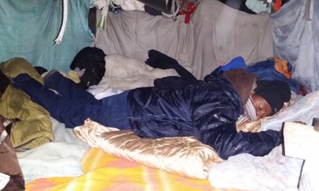 One of Feruz’s former classmates rests in his tent in Calais