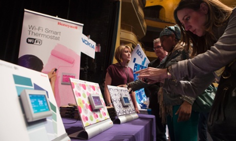 An attendee photographs the Honeywell International Inc. Wi-Fi Smart Thermostat displayed at Pepcom DigitalFocus in New York, on April 11, 2013.