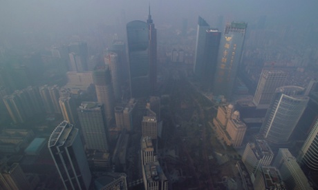 Buildings are seen through thick haze in the central business district of Guangzhou, part of the Pearl River Delta urban area.