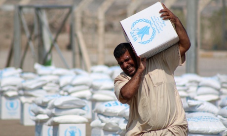 An Iraqi collects a food parcel distributed by the World Food Programme, which is assisting 50,000 displaced families in southern Iraq.