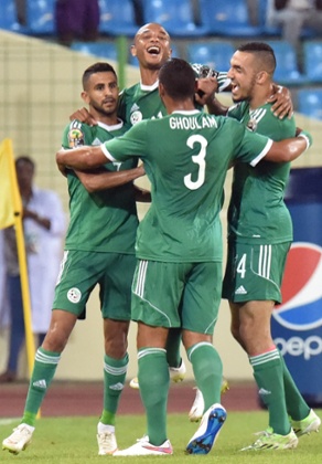 Algeria's Riyad Mahrez, left, is congratulated by team-mates after opening the scoring against Senegal