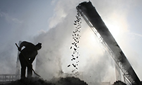 File photo shows a labourer working at a coal factory in Baicheng county