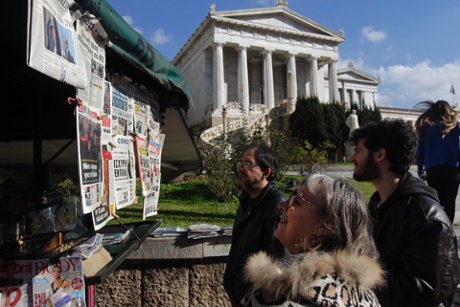 People read the front pages of newspapers in a kiosk in Athens, Greece, 26 January 2015.