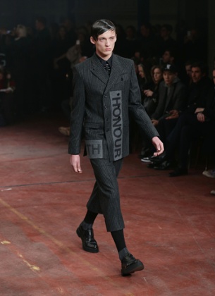 A model wearing a version of men's hoisery on the Alexander McQueen catwalk