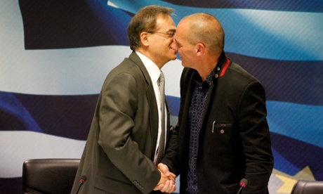 Greece's outgoing Finance Minister Gikas Hardouvelis, left, kisses the new Finance Minister Yanis Varoufakis during a handover ceremony in Athens.