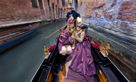 Couple in a gondola at Venice Carnival.