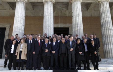 Greece's Prime Minister Alexis Tsipras, center, accompanied by members of his government poses for a group picture outside the Parliament in central Athens, Wednesday, Jan. 28, 2015.