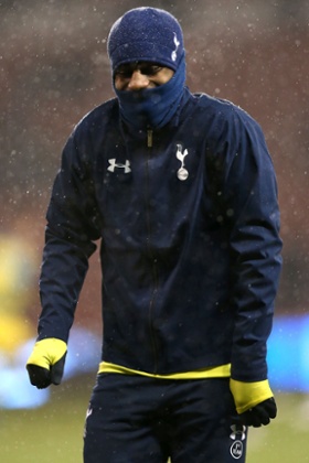 Tottenham Hotspur's Danny Rose takes the instruction to warm-up literally and applies multiple layers against the inclement weather