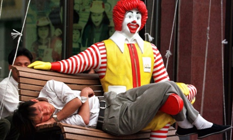 A man sleeps outside a McDonald's restaurant in Beijing