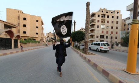 ISIL fighter waves black flag in Raqqa, Syria in June 2014