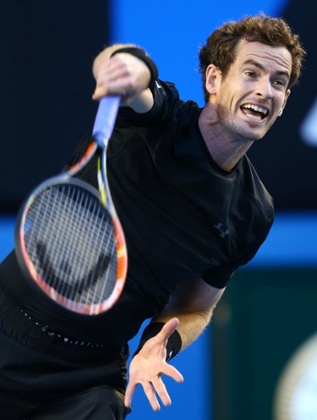 Andy Murray serves.