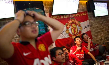Fans of Manchester United in Shanghai react as they watch their team in action