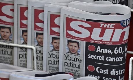 Copies of The Sun newspaper are seen on a newsstand