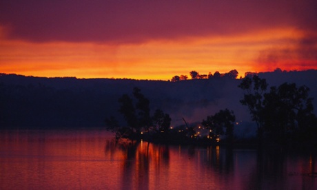 Embers glow against the smoke-filled sunset near Gumeracha in the Adelaide Hills on January 3, 2015.