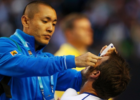 Stan Wawrinka receives eye drops from medical staff .