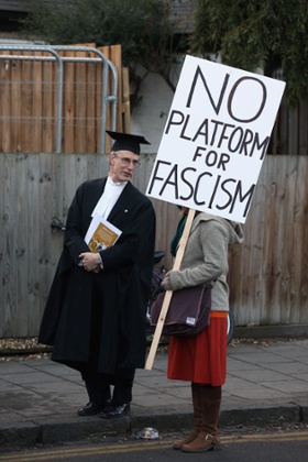 A Cambridge proctor speaks to a protestor