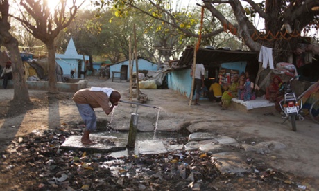 An Indian man drinks water from a roadside tap on the eve of World Water Day in Allahabad, India, Thursday, March 21, 2013. The U.N. estimates that more than one in six people worldwide do not have access to 20-50 liters (5-13 gallons) of safe freshwater a day to ensure their basic needs for drinking, cooking and cleaning.