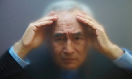 Man looking through frosty window