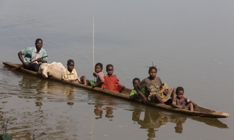 Valentine Pasi and her relatives cross the Ubangi river.