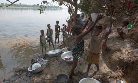 Refugees arriving from the Central African Republic  collect water and do their washing by the river Ubangi at Gbangara near Dula.