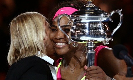 Serena Williams receives the trophy from Martina Navratilova.