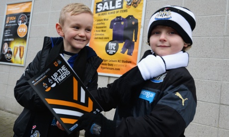 HULL, ENGLAND - JANUARY 31: Young Newcastle fans pose outside the ground prior to the Barclays Premier League match between Hull City and Newcastle United at KC Stadium on January 31, 2015 in Hull, England.  (Photo by Nigel Roddis/Getty Images)English Premier LeagueFootballSoccerClub SoccerEnglish Soccer ClubBallTeam Sport