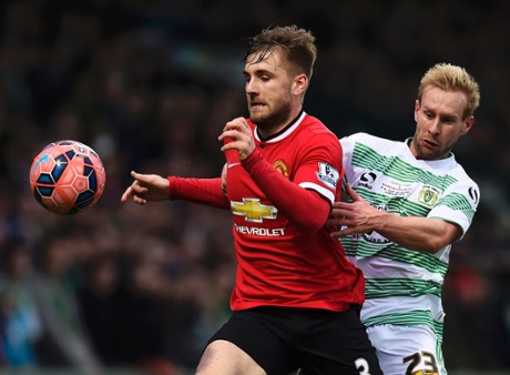 Luke Shaw holds off Simon Gillett.