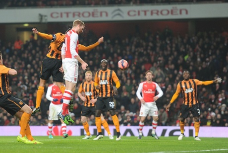 Per Mertesacker heads past Hull goalkeeper Steve Harper to score.