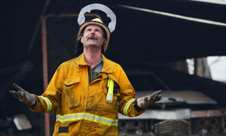A CFS volunteer reacts as rain starts to fall at One Tree Hill