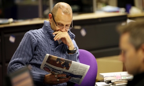 In a chunky knit while perusing a quality newspaper