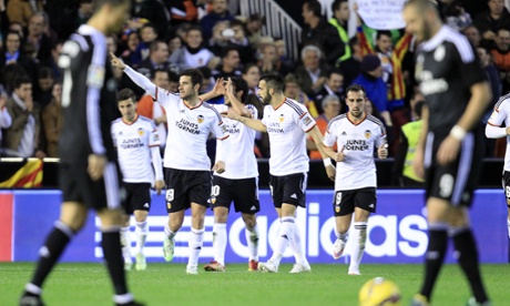 Valencia's Antonio Barragan, second left, celebrates after scoring against Real Madrid and helping to stop the club's 22-game winning streak.