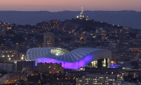 The Stade Vélodrome in Marseille, with Notre Dame de la Garde basilica in the background.