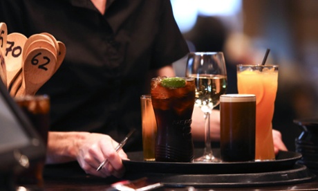 A waitress carries drinks at The Yew Tree pub in Great Horkesley, Essex