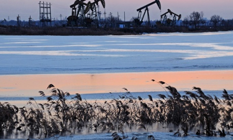 Oil rigs belonging to PetroChina are seen near the banks of a snow covered lake in Daqing in northeastern China's Heilongjiang province.