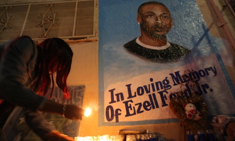 Tritobia Ford lights candles at a memorial for her son, Ezell Ford, at the site where he was shot and killed by two LAPD officers in August.