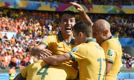 Australia's forward Tim Cahill (L) is congratulated by teammates after scoring during a Group B football match between Australia and the Netherlands at the Beira-Rio Stadium in Porto Alegre during the 2014 FIFA World Cup on June 18, 2014.