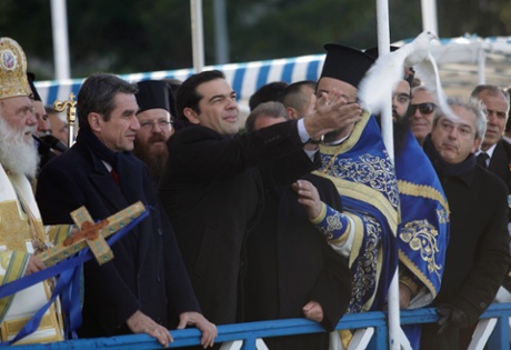 Leader of main opposition Radical Left Coalition party (SYRIZA) Alexis Tsipras (C) releases a white pigeon next to Archbishop Ieronymos (L) during a ceremony to celebrate the Orthodox Epiphany Day in Piraeus near Athens, Greece, 06 January 2015.
