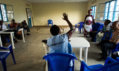 A UN-paid mediator leads a meeting of the Permanent Local Reconciliation Committee (CLPC) in the town of Sake, in the Masisi region of North Kivu, July 25, 2014. Standing is CLPC member Judith Ndoole.