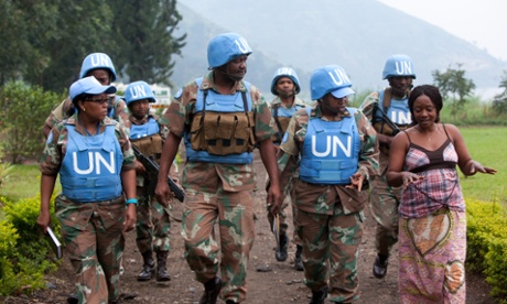 Major Steven Matodon, public information officer for the South African U.N. brigade, center, leads a handpicked group of mostly female U.N. soldiers on a 